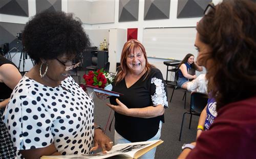 Deidre Deal looks at old yearbooks with former students